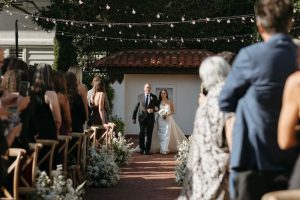 Wedding ceremony entrance with overhead string lights at Darlington House wedding lighting in San Diego