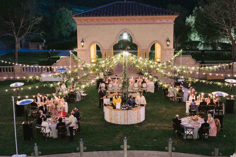Fairmont Grand Del Mar wedding lighting with market lights and greenery canopy over outdoor reception layout in San Diego