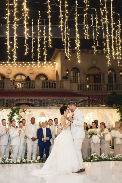 Fairmont Grand Del Mar wedding lighting with cascading twinkle lights above first dance and illuminated reception space