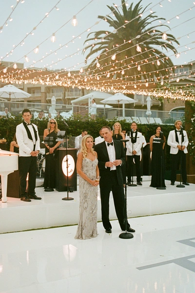 Montage Laguna Beach wedding lighting with market lights over outdoor stage and reception during sunset in Laguna Beach