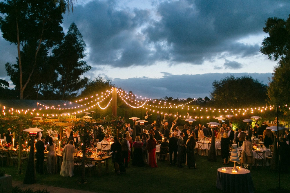 Rancho Valencia wedding lighting with market lights and candlelit outdoor reception creating warm evening ambiance