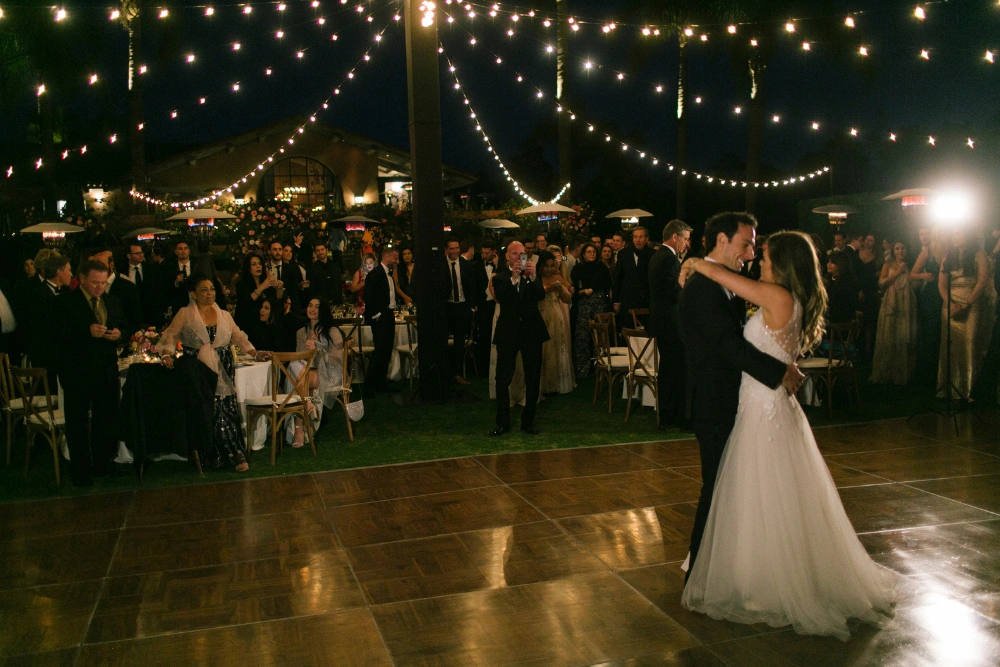 Rancho Valencia wedding lighting with market lights over outdoor dance floor during evening reception in San Diego
