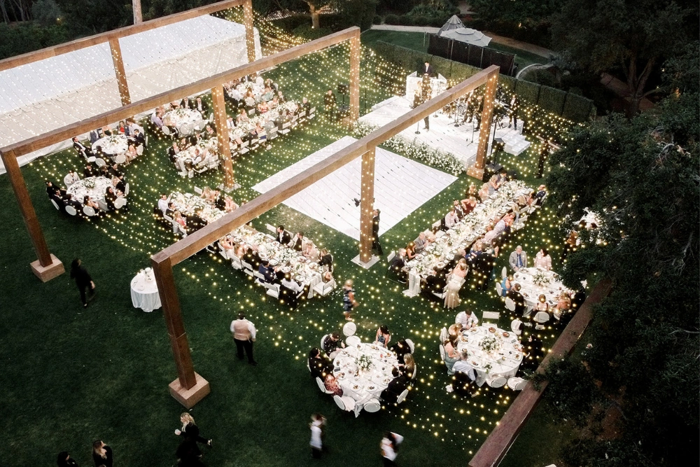 Rancho Valencia wedding lighting with full twinkle canopy and illuminated lawn reception from aerial view