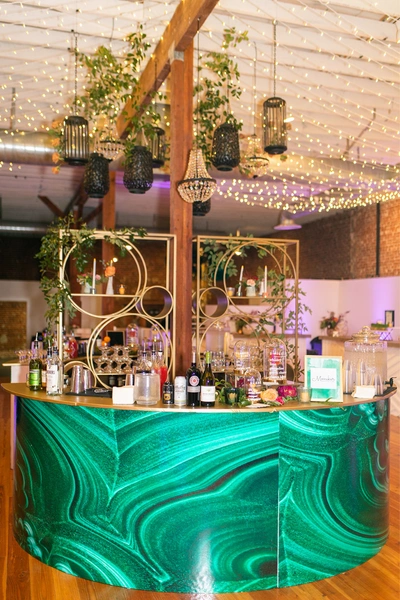 Sinclair on G Street wedding lighting with twinkle canopy and decorative hanging lanterns above custom bar setup in San Diego