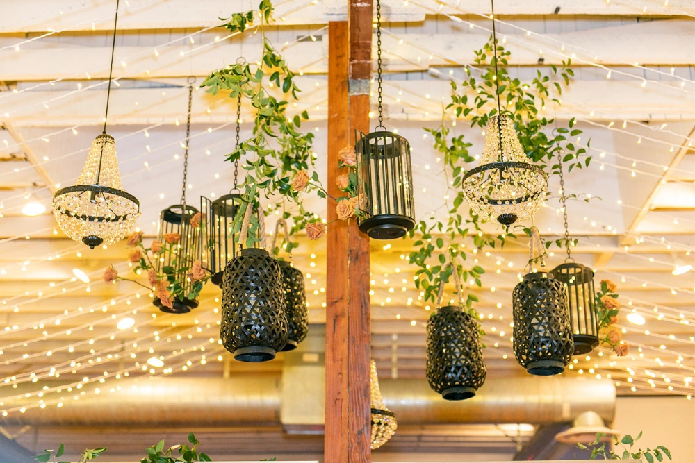 Sinclair on G Street wedding lighting with chandeliers, greenery, and twinkle lights creating warm indoor ambiance