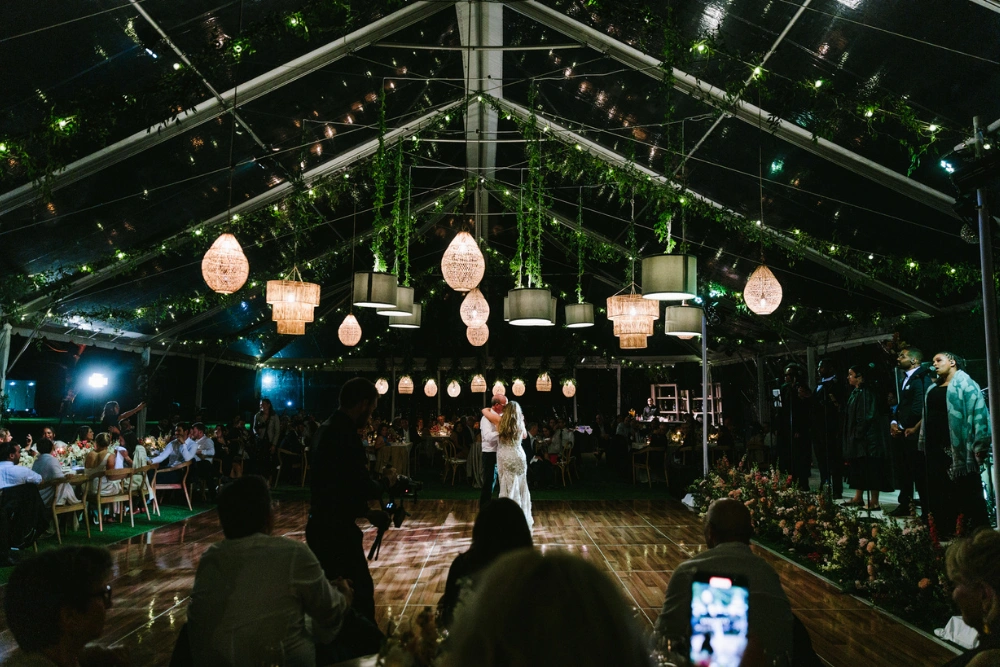 The Ranch at Laguna Beach wedding lighting with twinkle lights and hanging pendant lights inside tented reception