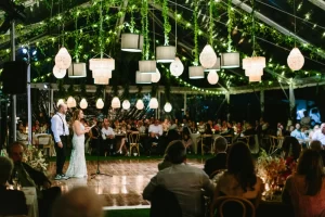 The Ranch at Laguna Beach wedding lighting with canopy lights and hanging fixtures creating warm ambiance during reception speeches