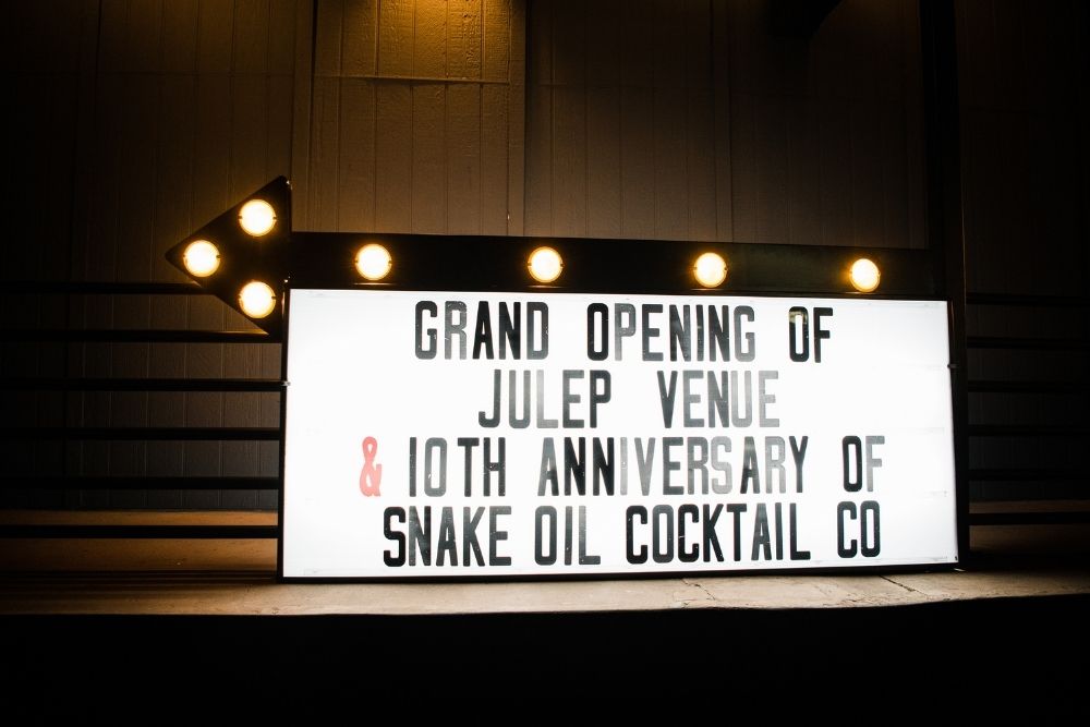 Illuminated marquee sign with vintage bulbs at Julep venue showcasing custom wedding lighting features